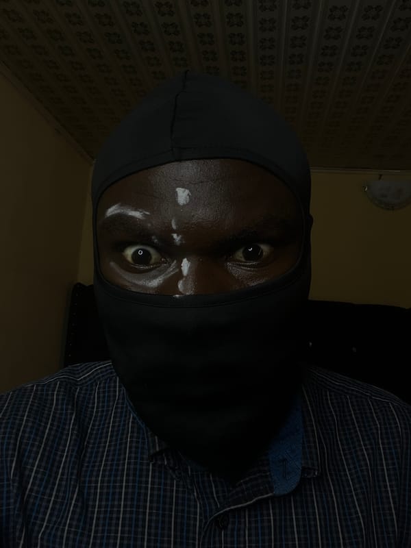 Masked individual photographed indoors in Gura Top, Nigeria