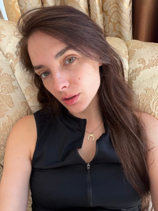 Relaxing on a gold sofa in Ufa, crescent moon necklace