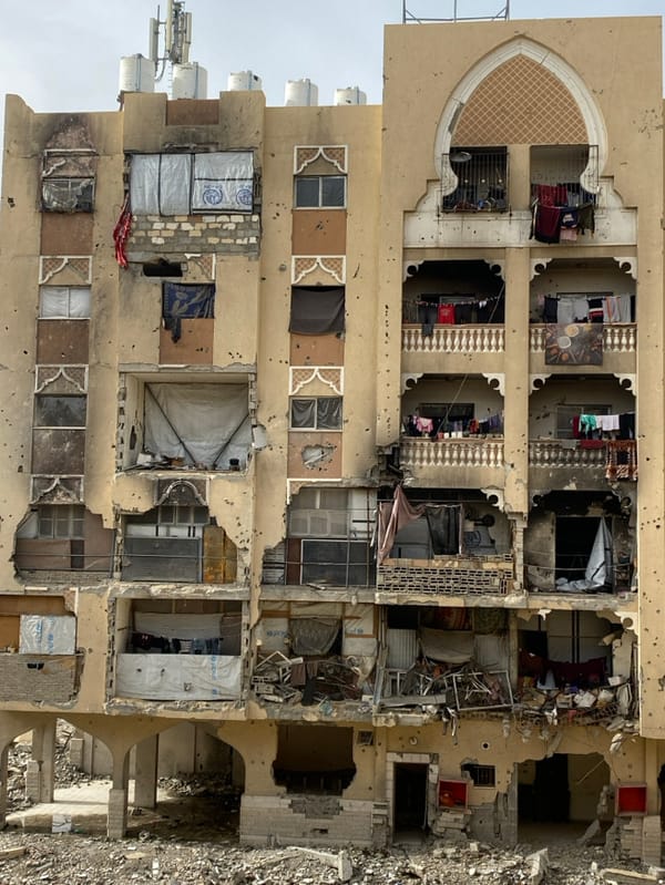 Khan Yunis residents grill food amid damaged buildings