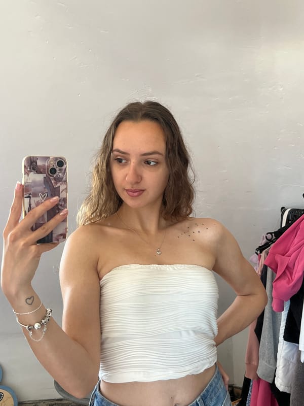 Woman takes multiple selfies indoors in Saarbrücken