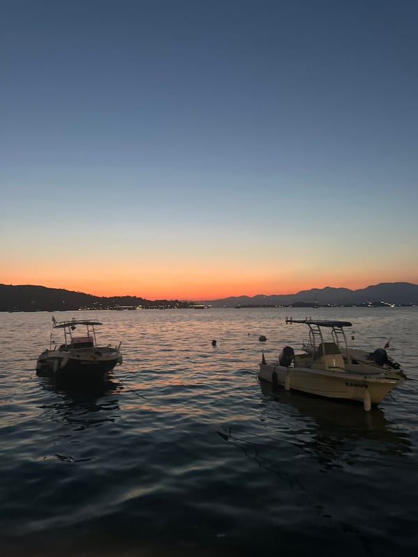 Fethiye harbor at dusk, boats moored under a gradient sky