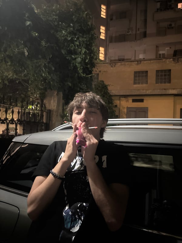 Person smoking cigarette observed in Turin at night