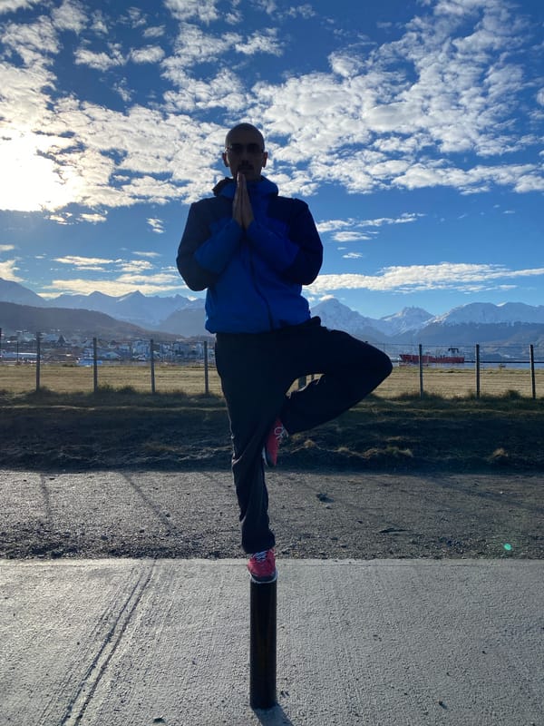 Man in blue jacket stands on path in Ushuaia