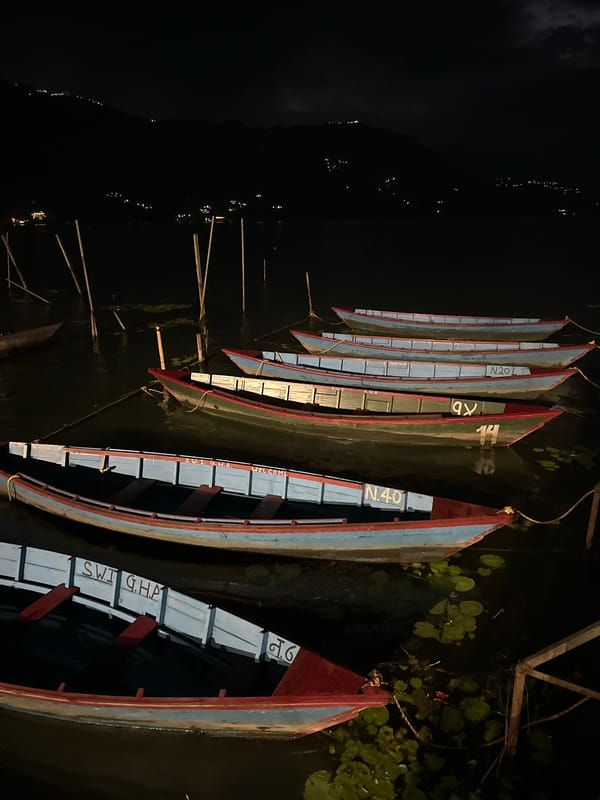 Colorful boats docked at Phewa Lake, Pokhara at night