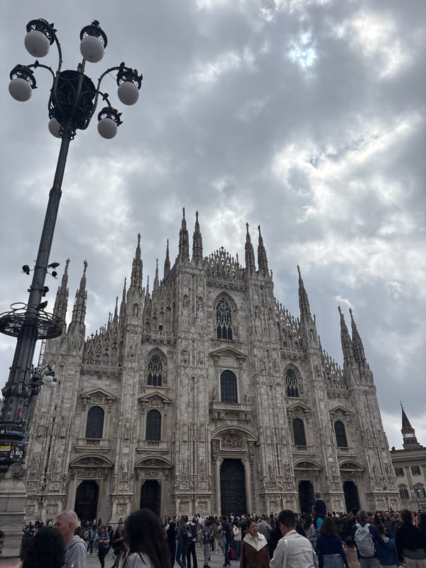 Tourist captures Milan cathedral and luxury shopping gallery visit