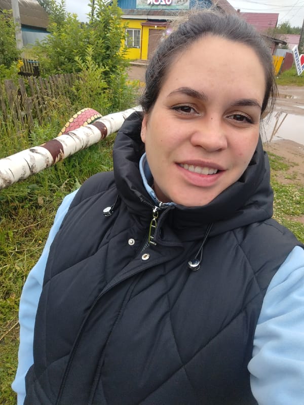 Outdoor portrait in rural Rusalevka, black vest and blue hoodie