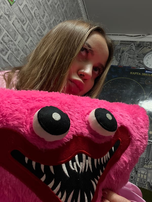 Woman poses with pink monster plush toy in Russia