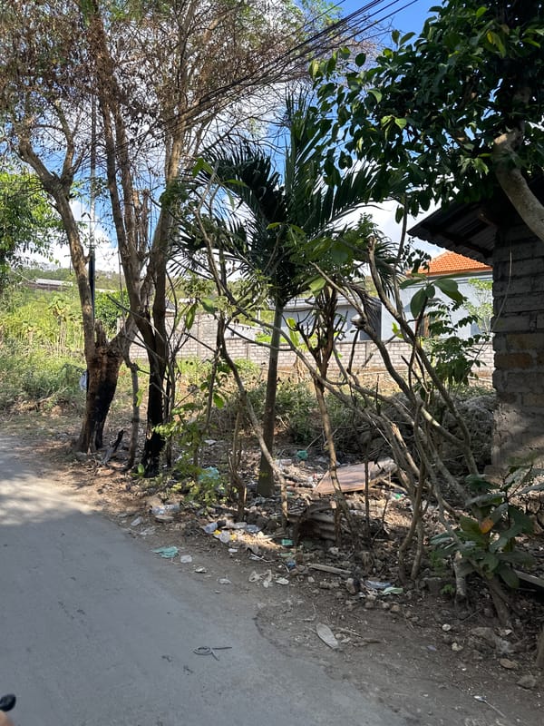 Scooter on a gravel road, Kuta Selatan roadside scene