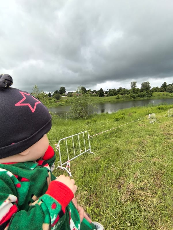 Child observed under overcast sky near Russian parking area