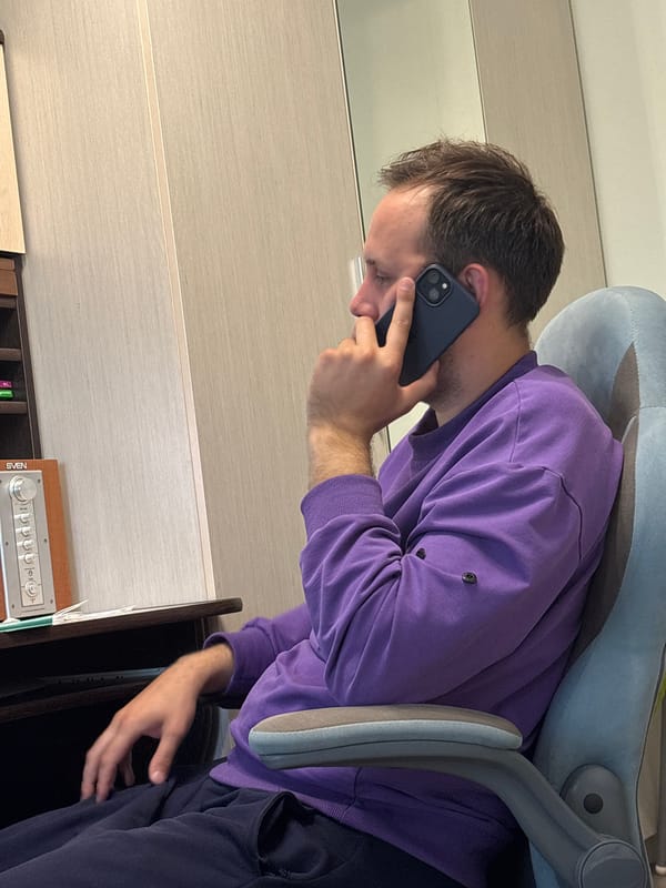 Man in purple sweater observed indoors in Rusanovo
