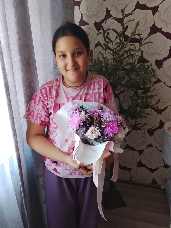 Girl with flower bouquet spotted in Kuyeda, Russia