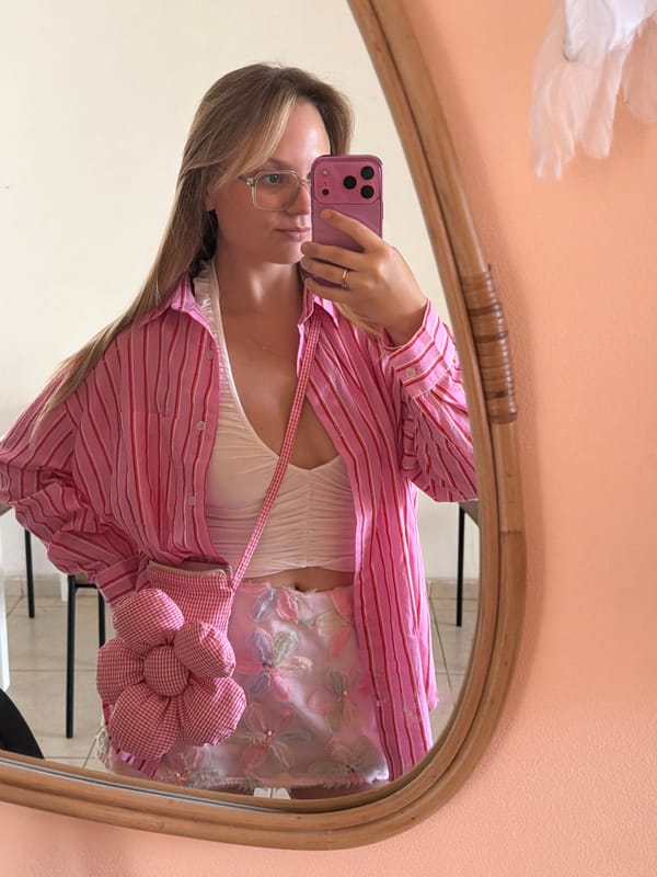 Mirror selfie featuring a layered floral outfit in Tel Aviv