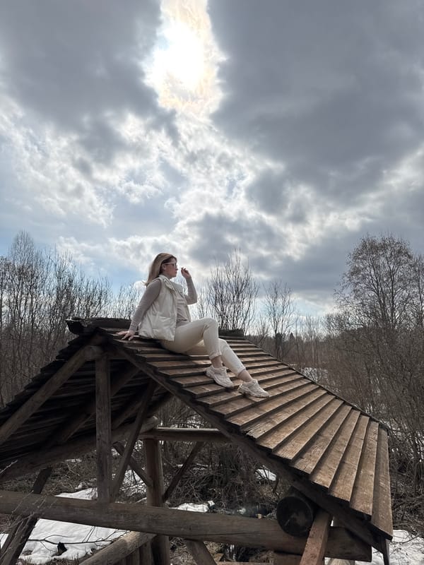Woman climbs wooden structures in rural Russian village
