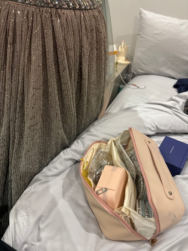 Personal items and jewelry organized on bedroom bedding in Durban