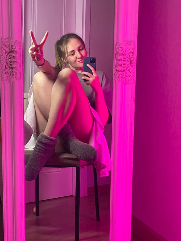 Woman documents extended mirror selfie session with pets in Batumi