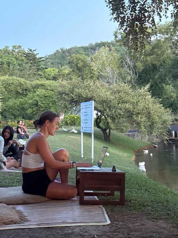 Young adults enjoy lakeside picnic with ducks in Pecatu