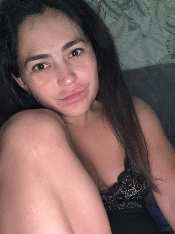 Woman rests on bed in Kauchuk Stantsiya, Russia
