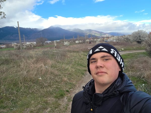 Young man takes selfie on dirt path in Yahinovo