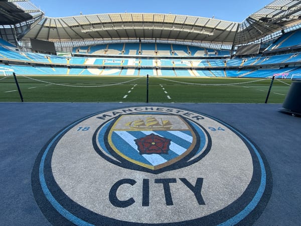 Empty Etihad Stadium captured from pitch level perspective