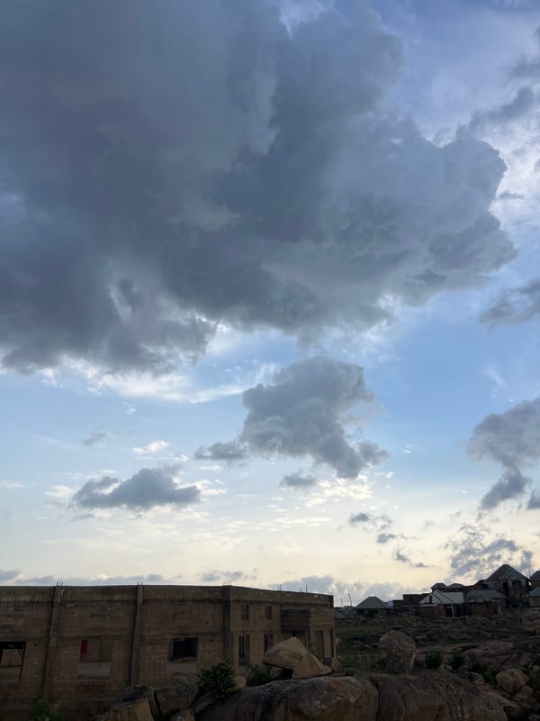 Storm clouds gather over Jos, Nigeria from rocky overlook