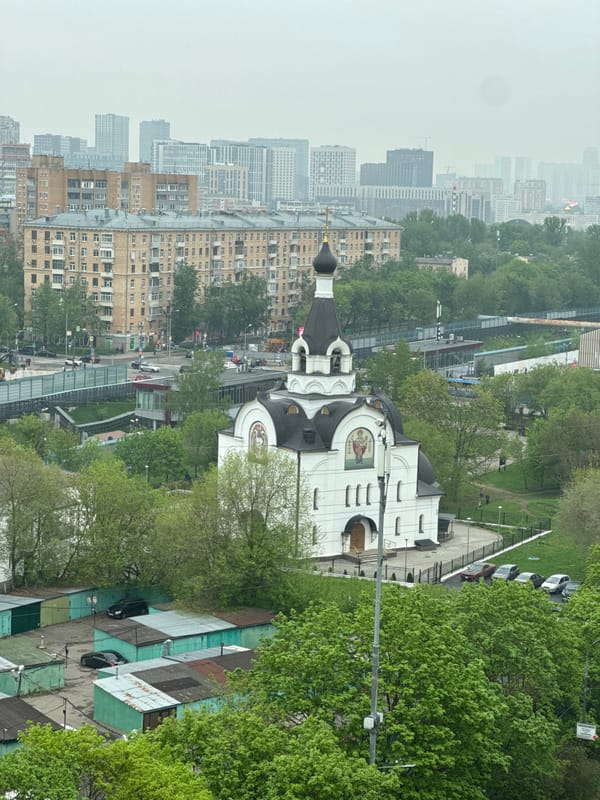 Elevated view captures white-domed church in urban cityscape