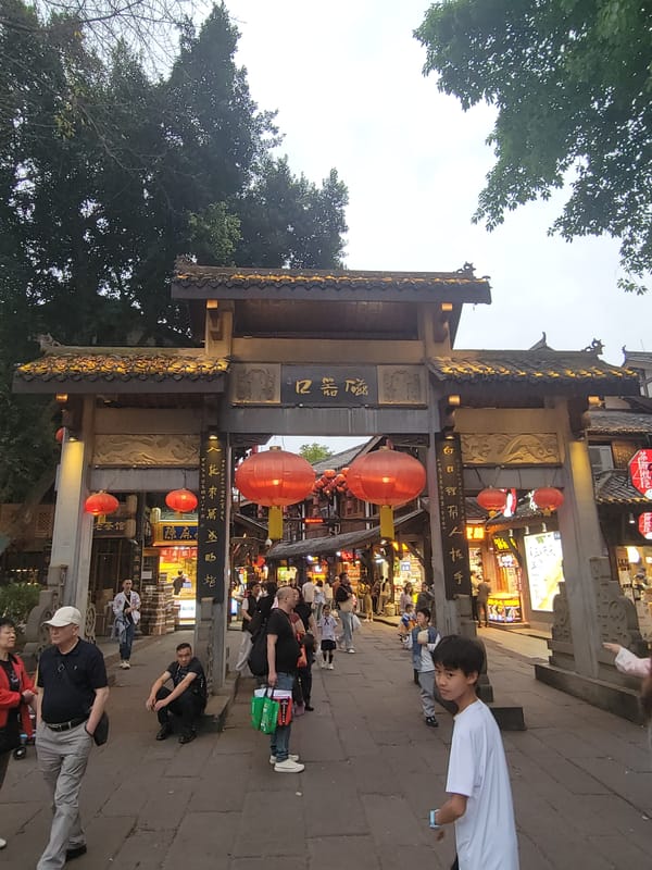 Traditional Chinese street district bustling with pedestrians and vendors