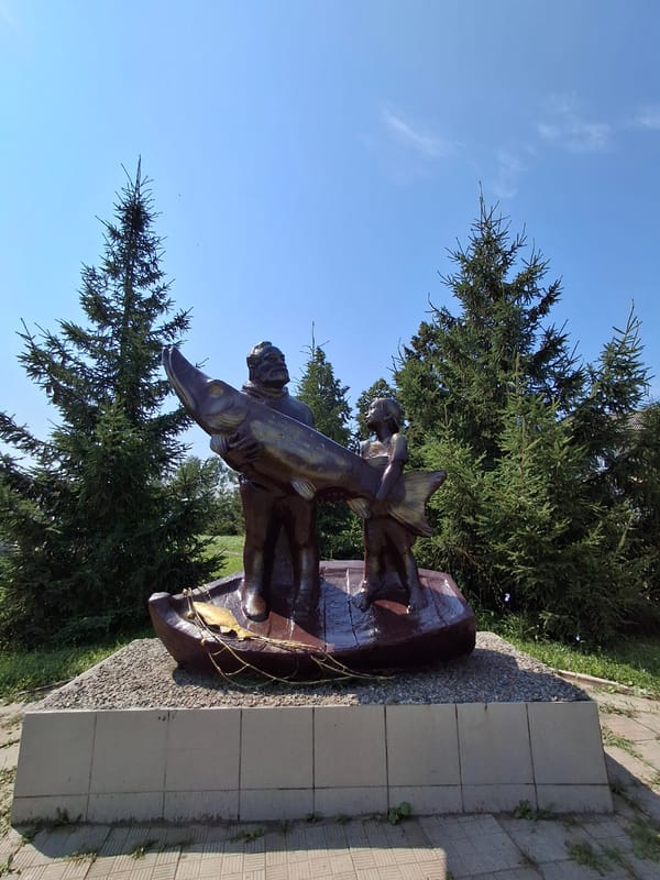 Fish sculptures and public art fill a sunny Elovo park