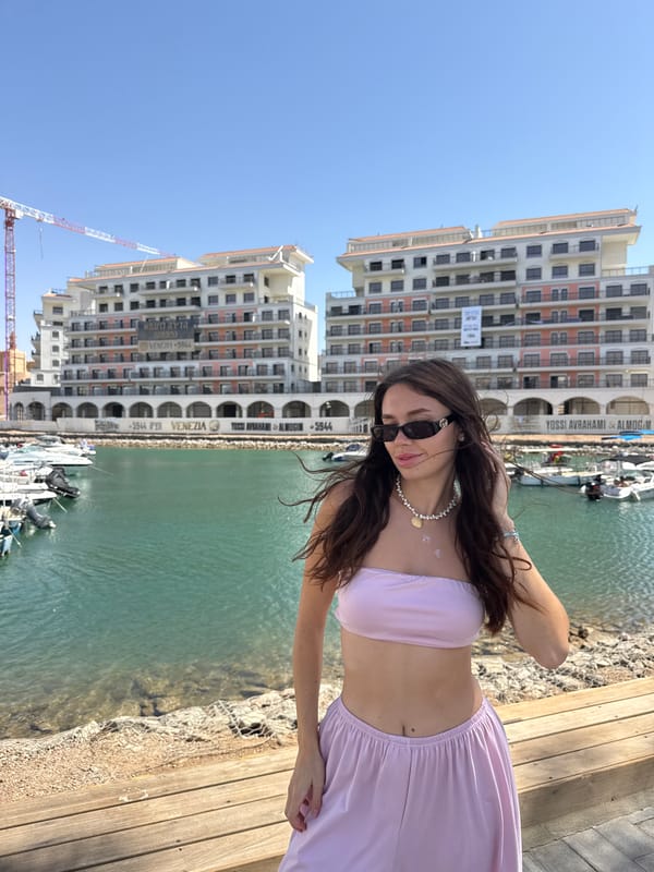 Woman poses by waterfront in Eilat, Israel