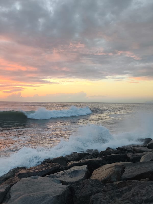Black Sea sunset breaks over Batumi's rocky Boulevard shore