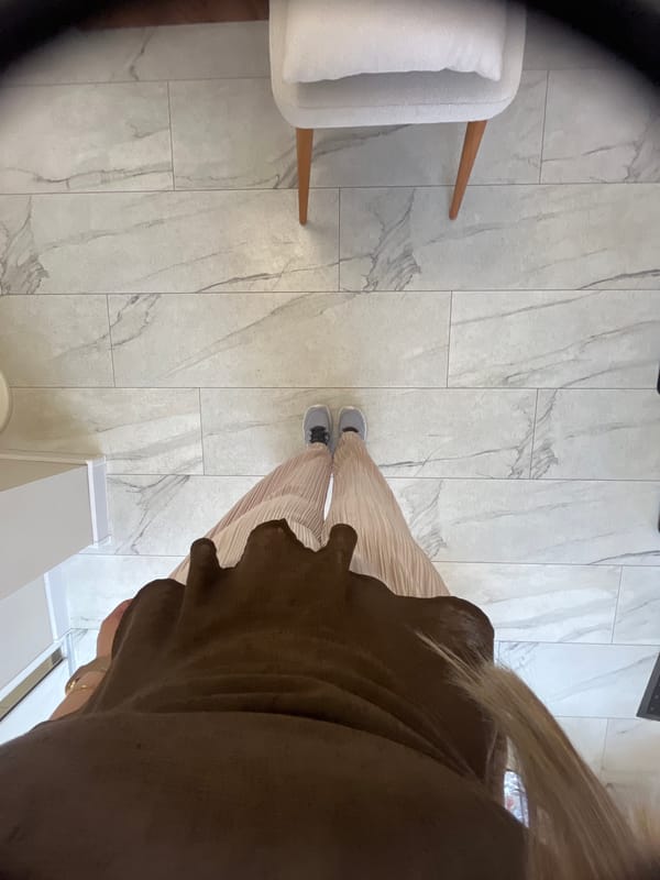Woman documents selfie session in commercial indoor space