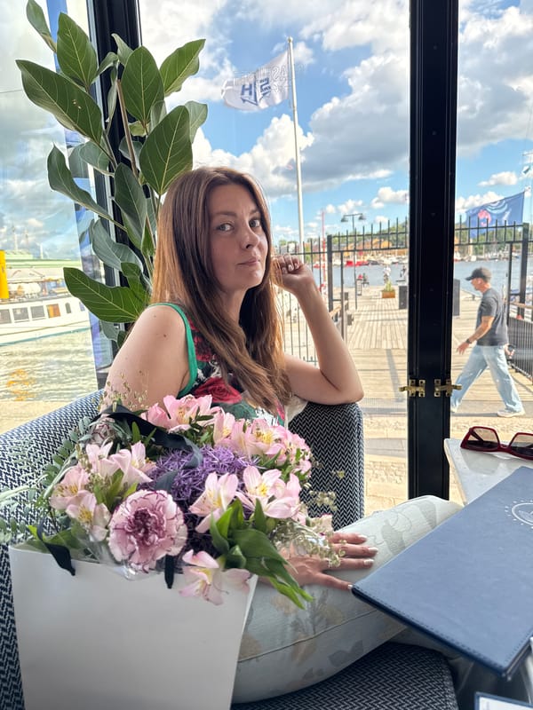 Relaxed pose in a Stockholm armchair with a bouquet nearby