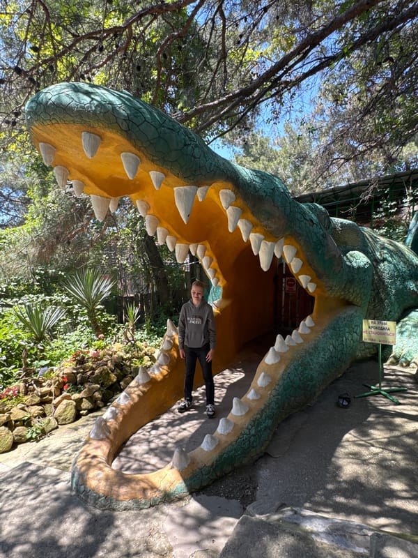 Large crocodile sculpture serves as walkway entrance for visitors