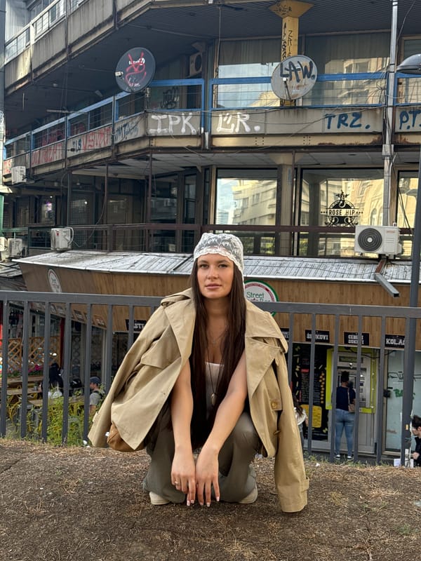 Woman poses for photos in lace headwear near Belgrade railing