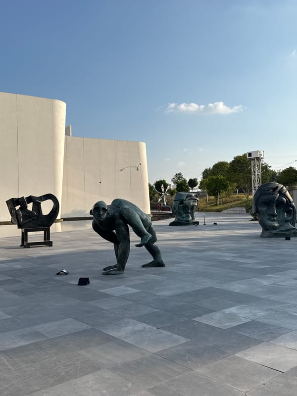 Visitor documents bronze sculptures at International Baroque Museum