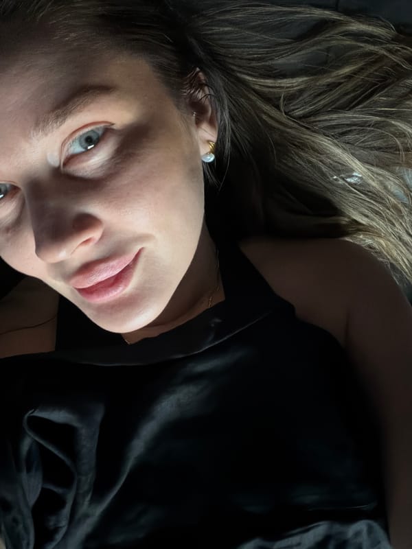 Woman photographed in Moscow wearing black top, rose-gold necklace