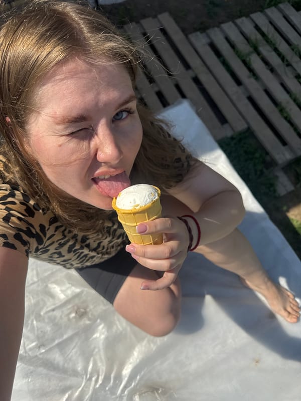 Woman enjoys ice cream on sunny morning in Ферма
