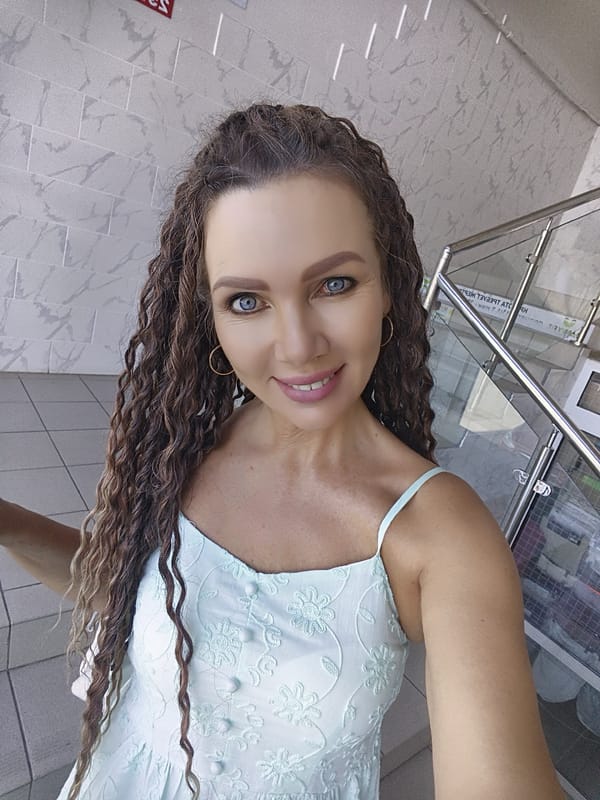 Indoor selfie session in a light blue floral dress