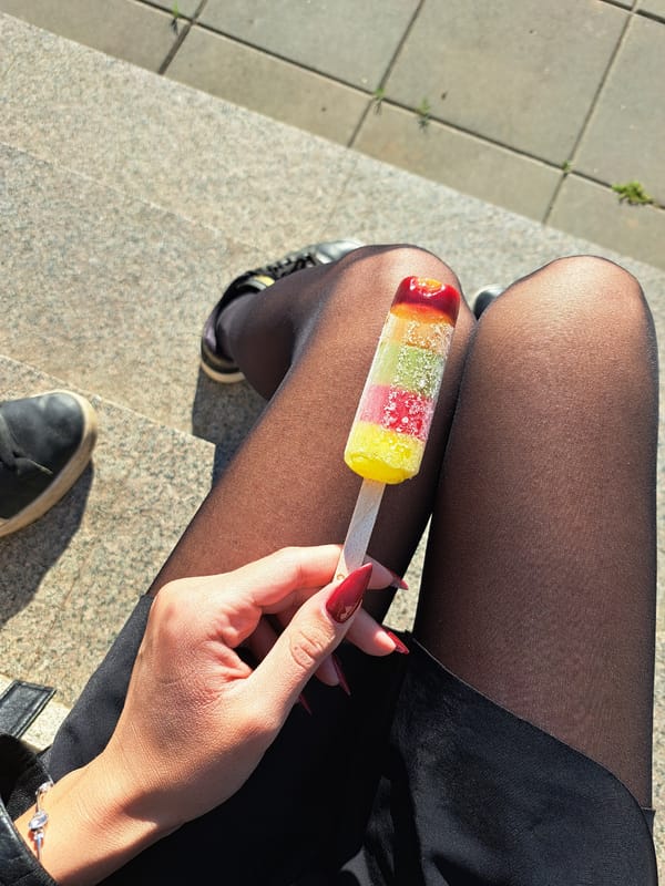 Casual popsicle moment captured on steps in Negovan, Bulgaria