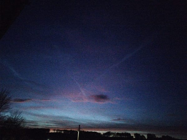 Twilight sky photographed over silhouetted landscape during evening hours