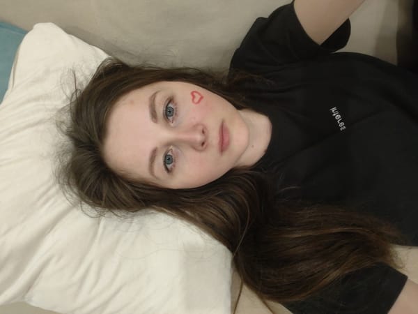 Person with heart marking rests on sofa, shadow captured