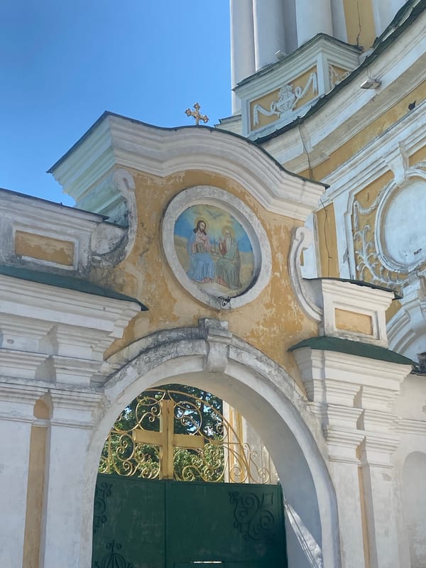 Tourist documents historic churches during sunny morning walk in Chernihiv