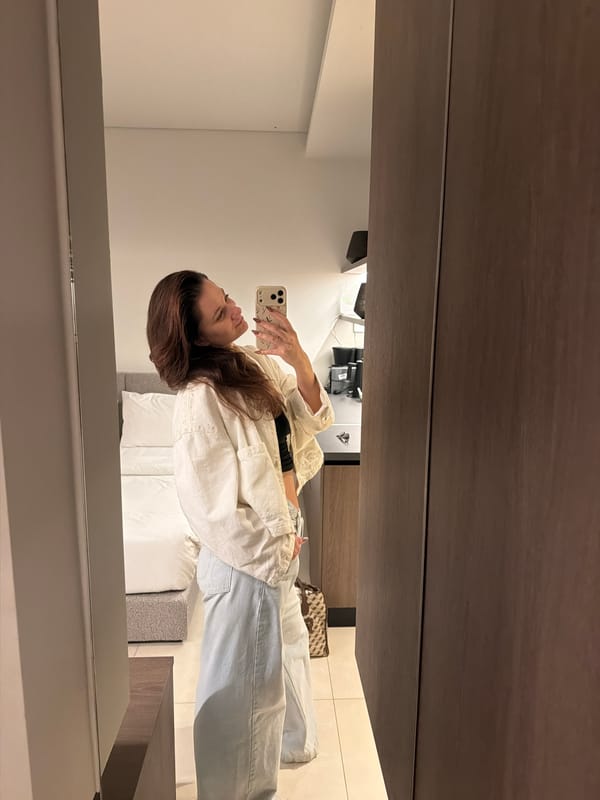 Person takes mirror selfie in modern Athens interior