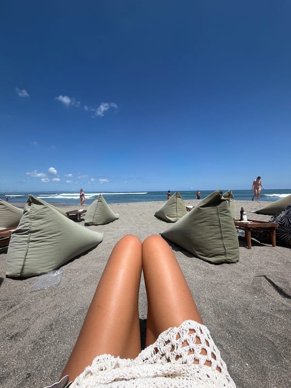 Dog sleeps on volcanic beach in North Kuta, Indonesia
