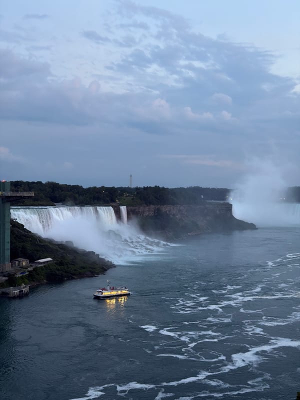 Horseshoe Falls at dusk, lit tour boat in the mist