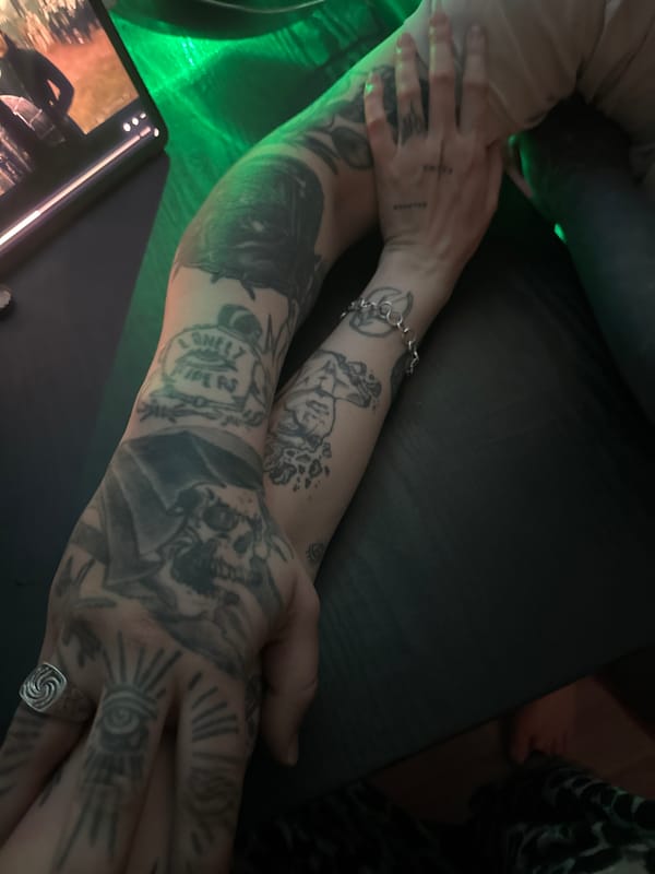 Tattooed hands, green crystal light, and LED-lit curtains in Moscow