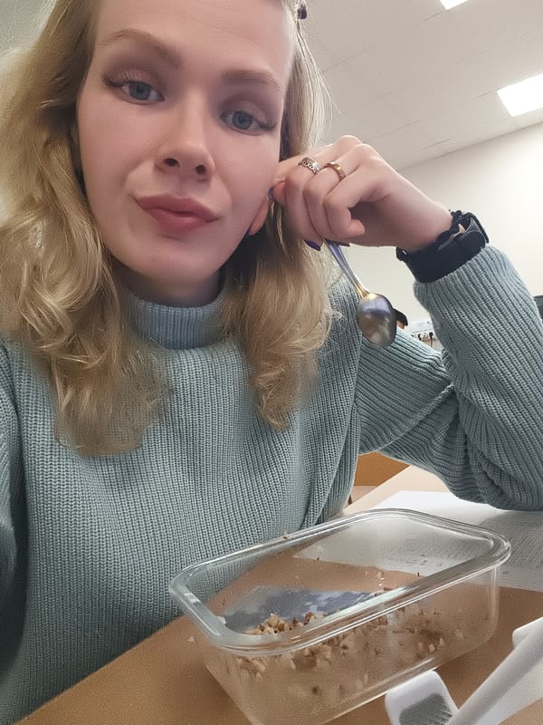 Woman takes morning selfies at office desk