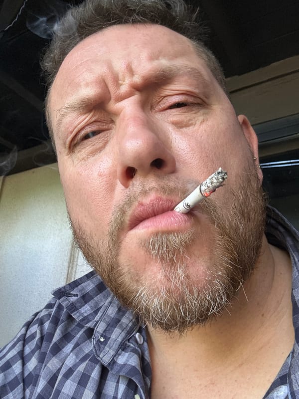 Man smoking observed among scattered items in Russian village