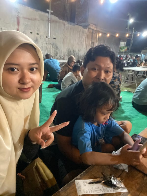 Family enjoys outdoor meal together in Sidoarjo, Indonesia
