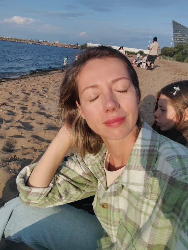 Sunny afternoon on a Saint Petersburg beach, Lakhta Center backdrop.