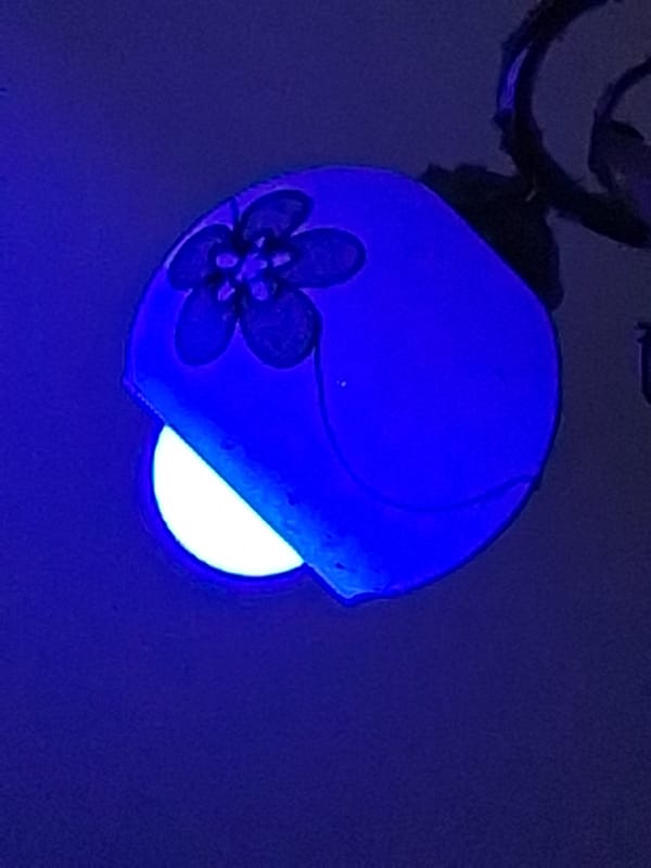 Blue-lit indoor scenes captured in Varna show lamp and tattoo